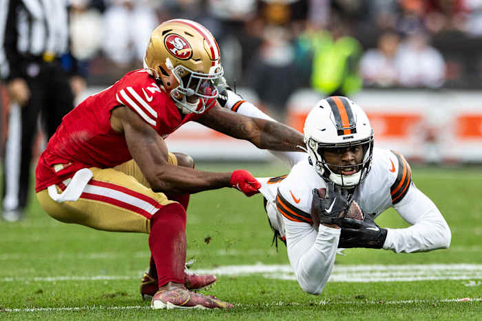 Cleveland Browns wide receiver David Bell (18) makes a diving catch as San Francisco 49ers cornerback Charvarius Ward (7) pulls him down during the fourth quarter at Cleveland Browns Stadium.